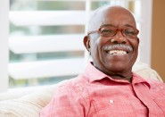 older man wearing glasses and smiling